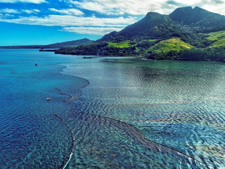 A drone image shows the oil spillage near the area where the bulk carrier ship MV Wakashio, belonging to a Japanese company but Panamanian-flagged, ran aground on a reef, at Riviere des Creoles, Mauritius. REUTERS/Reuben Pillay